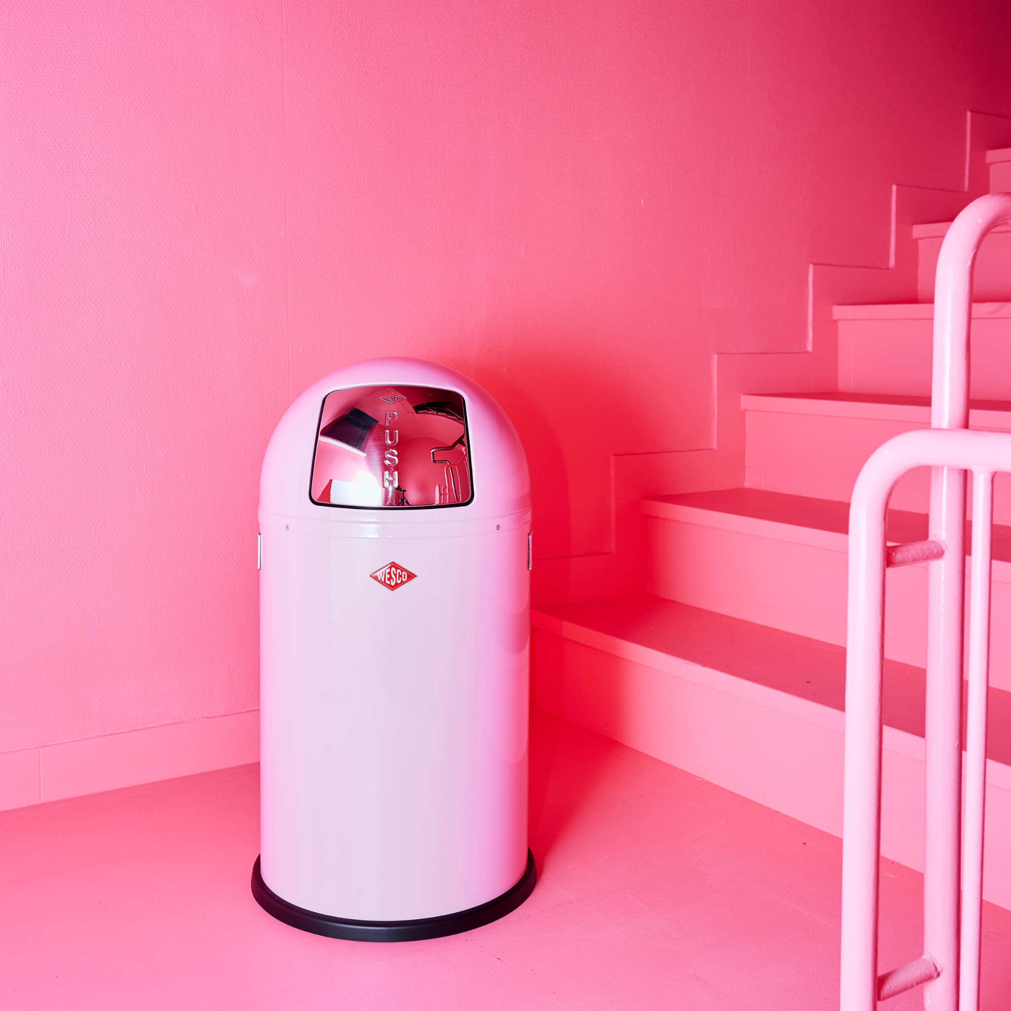 Pink Pushboy Junior next to a pink staircase