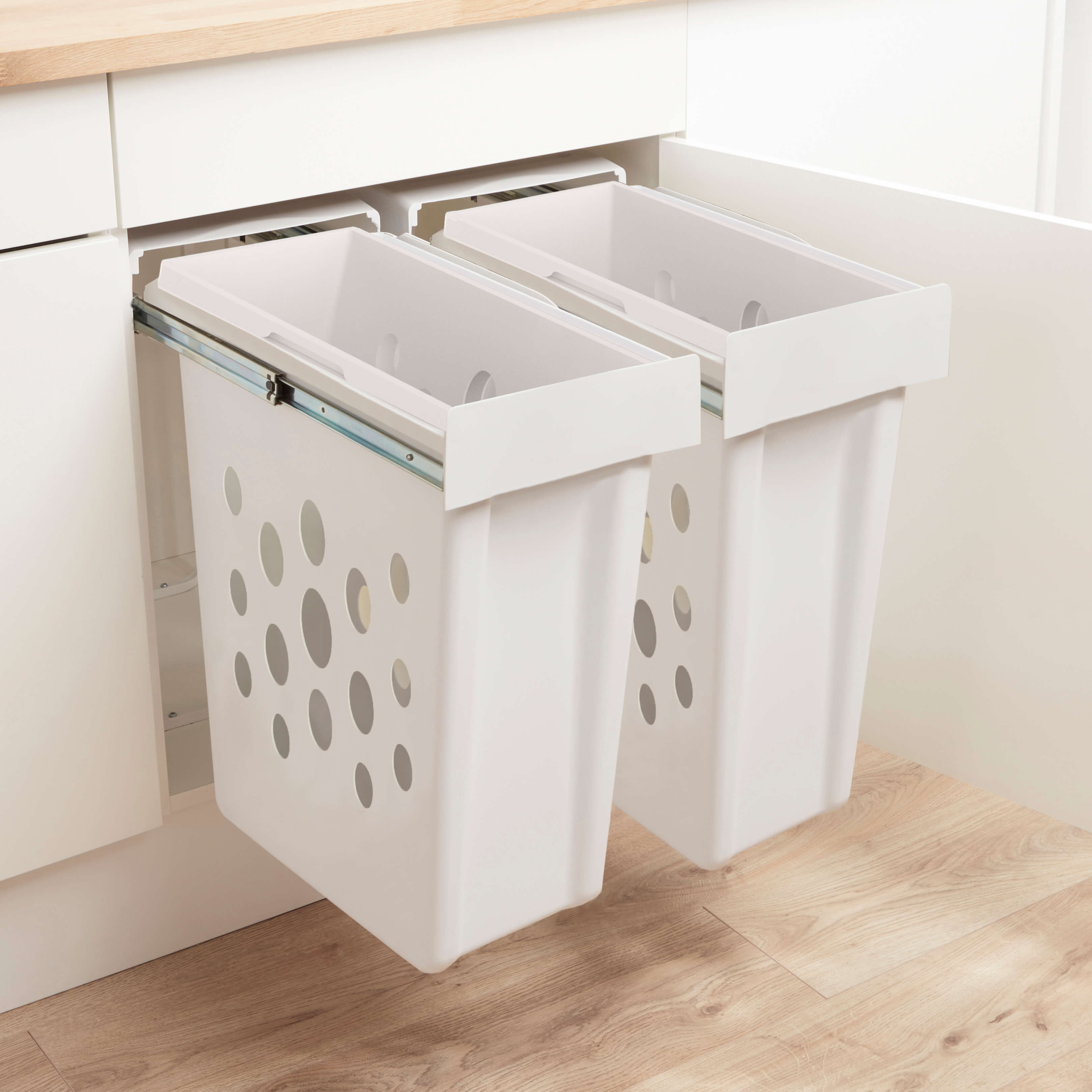 Wesco Laundry Boy in a twin set up with laundry baskets side by side within a kitchen cabiet.
