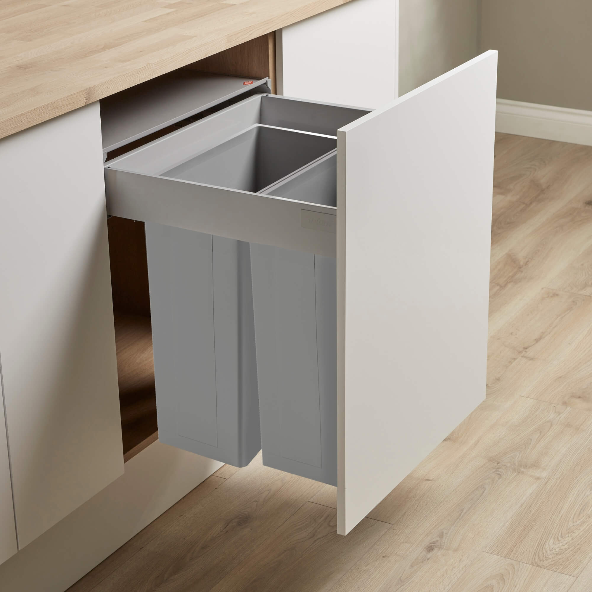 Wesco integrated recycling bin system with a 600mm door, featuring a grey steel frame and two grey plastic inner bins, mounted within a kitchen cabinet.