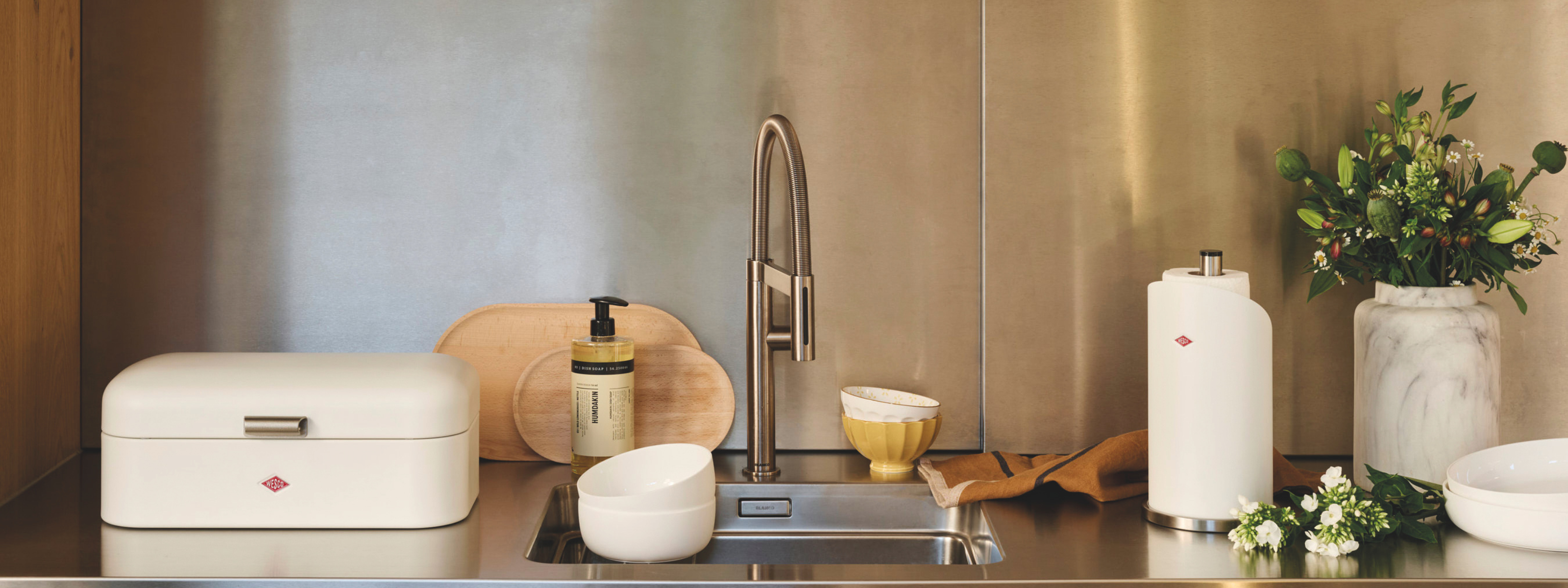 Modern kitchen picturing the sink area with Wesco Accessories and Large Bread Bin in Matt Sand
