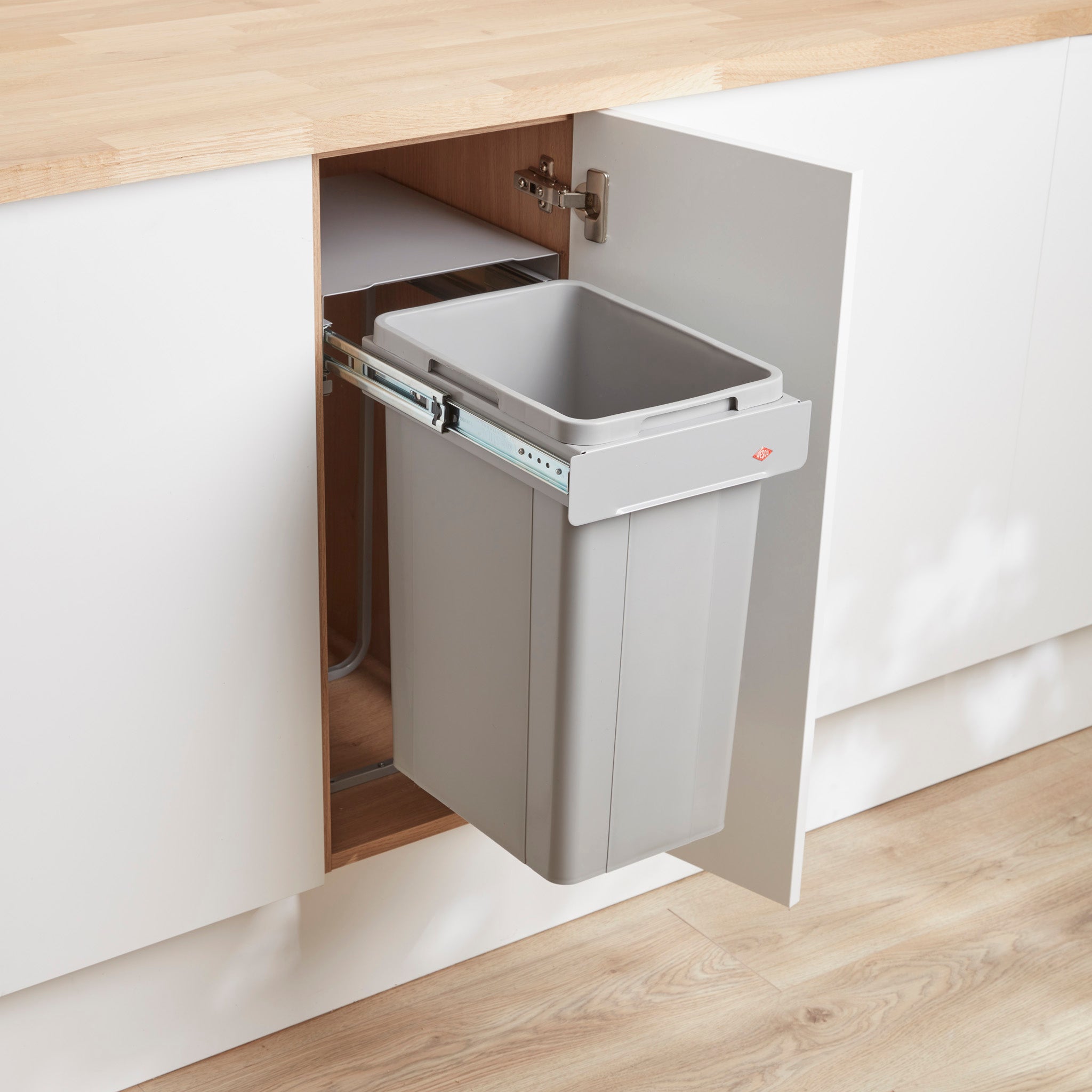 Wesco Alu Grey Bio Single waste bin pull-out system mounted inside a kitchen cabinet, designed to be used with a hinged door