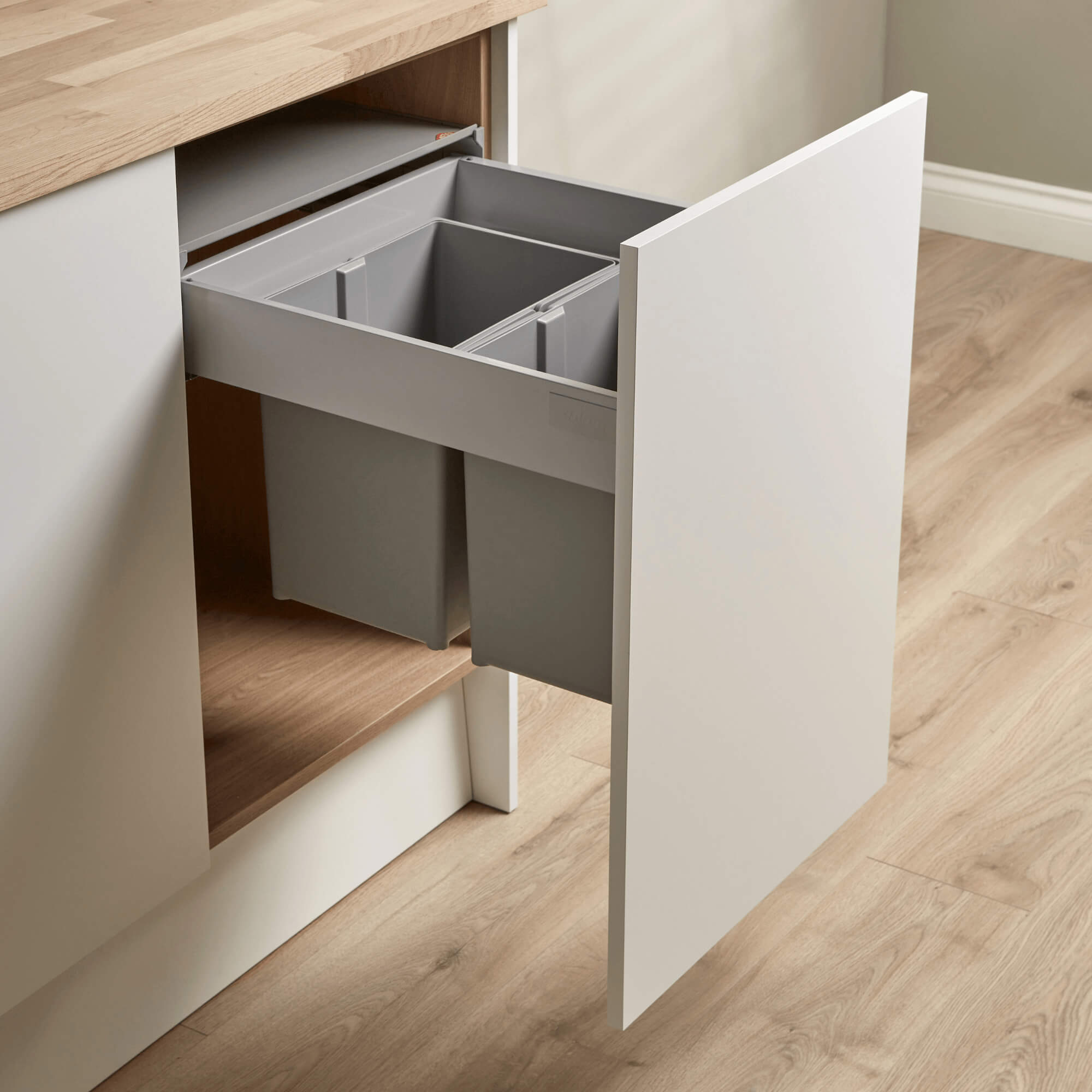 Wesco Pullboy Z 500mm integrated recycling bin system with two compartments, light grey in colour, mounted within a kitchen cabinet door.