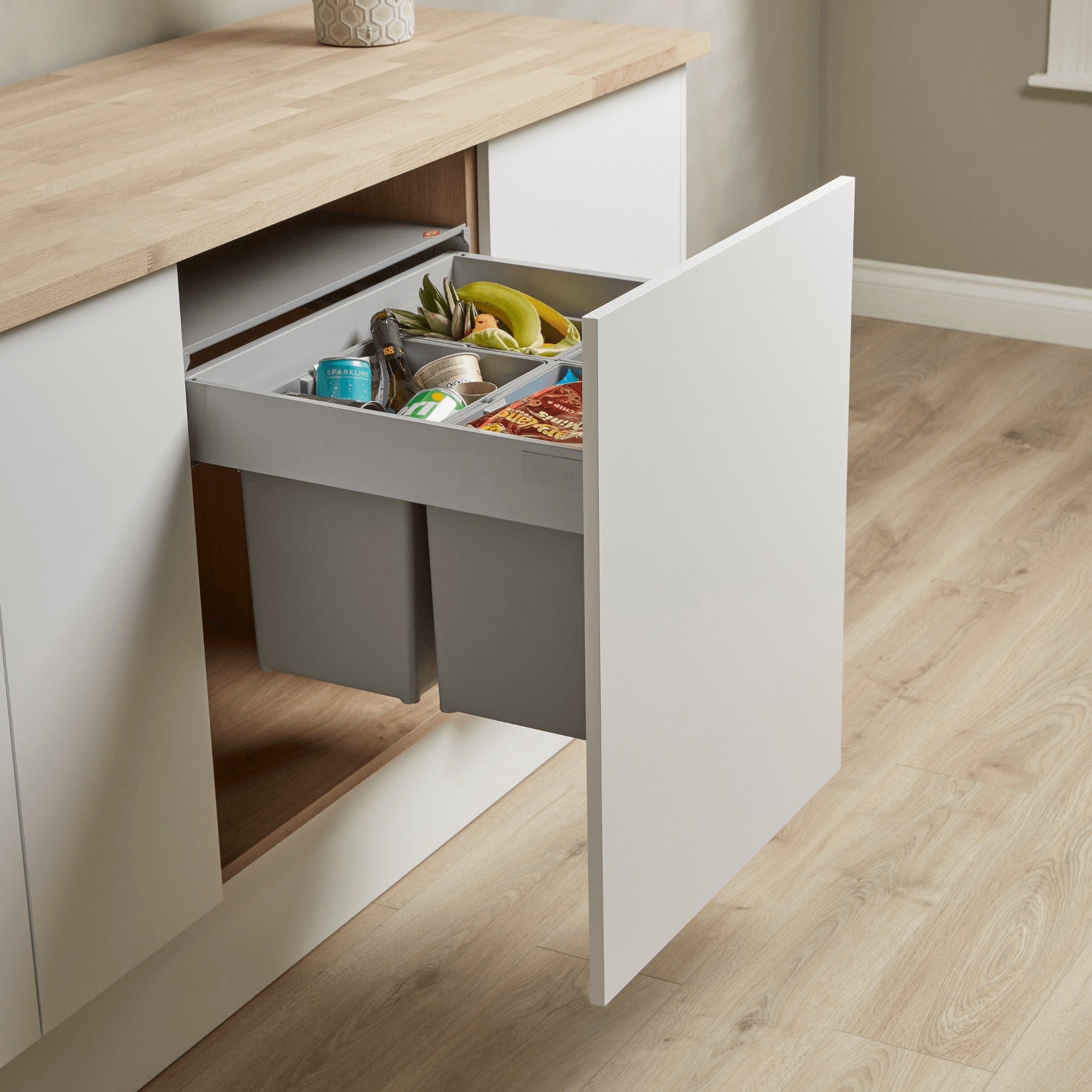 Wesco Pullboy Z 4 compartment 600mm pull-out waste bin filled with recycling.