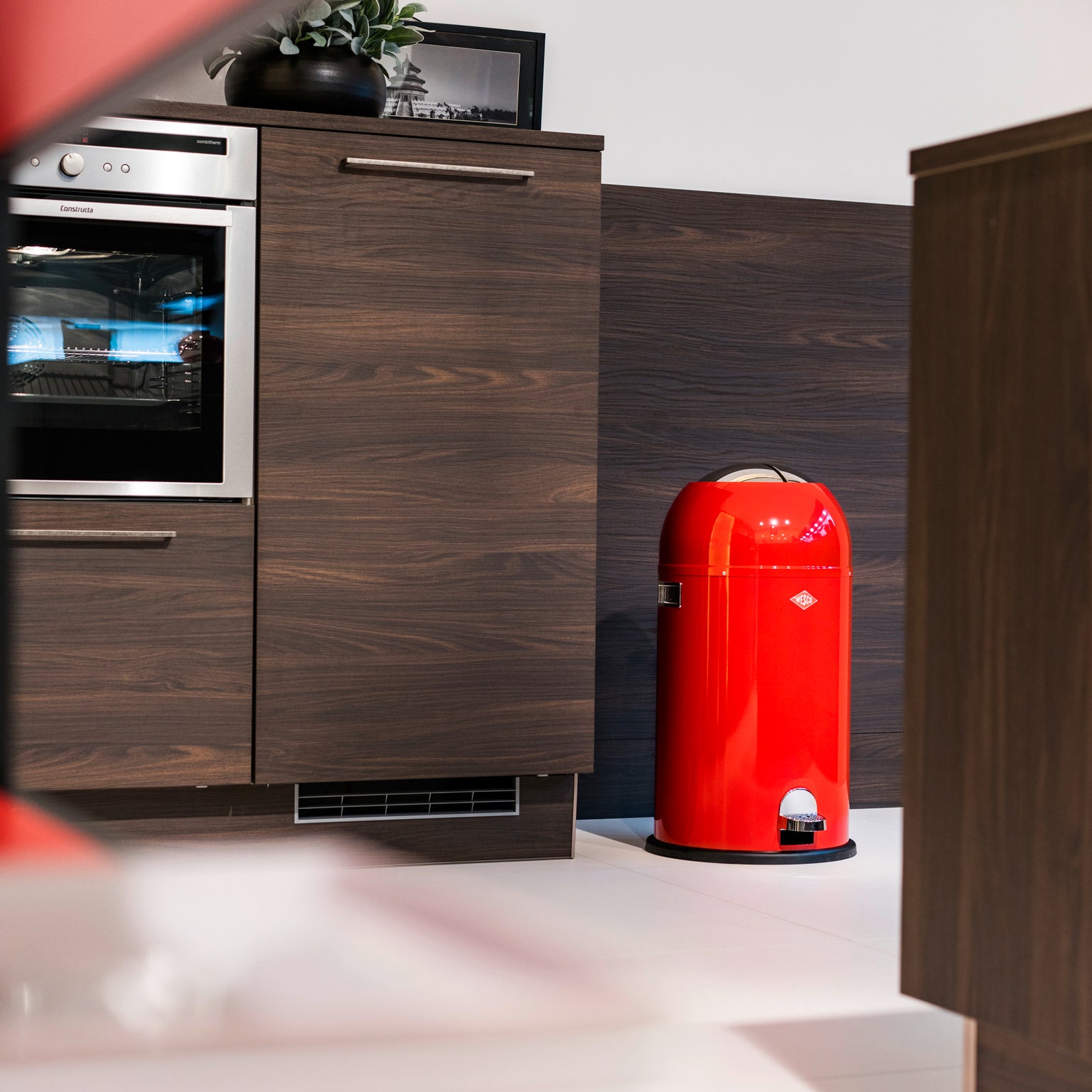 Lifestyle image of the Wesco Kickmaster pedal in in red.