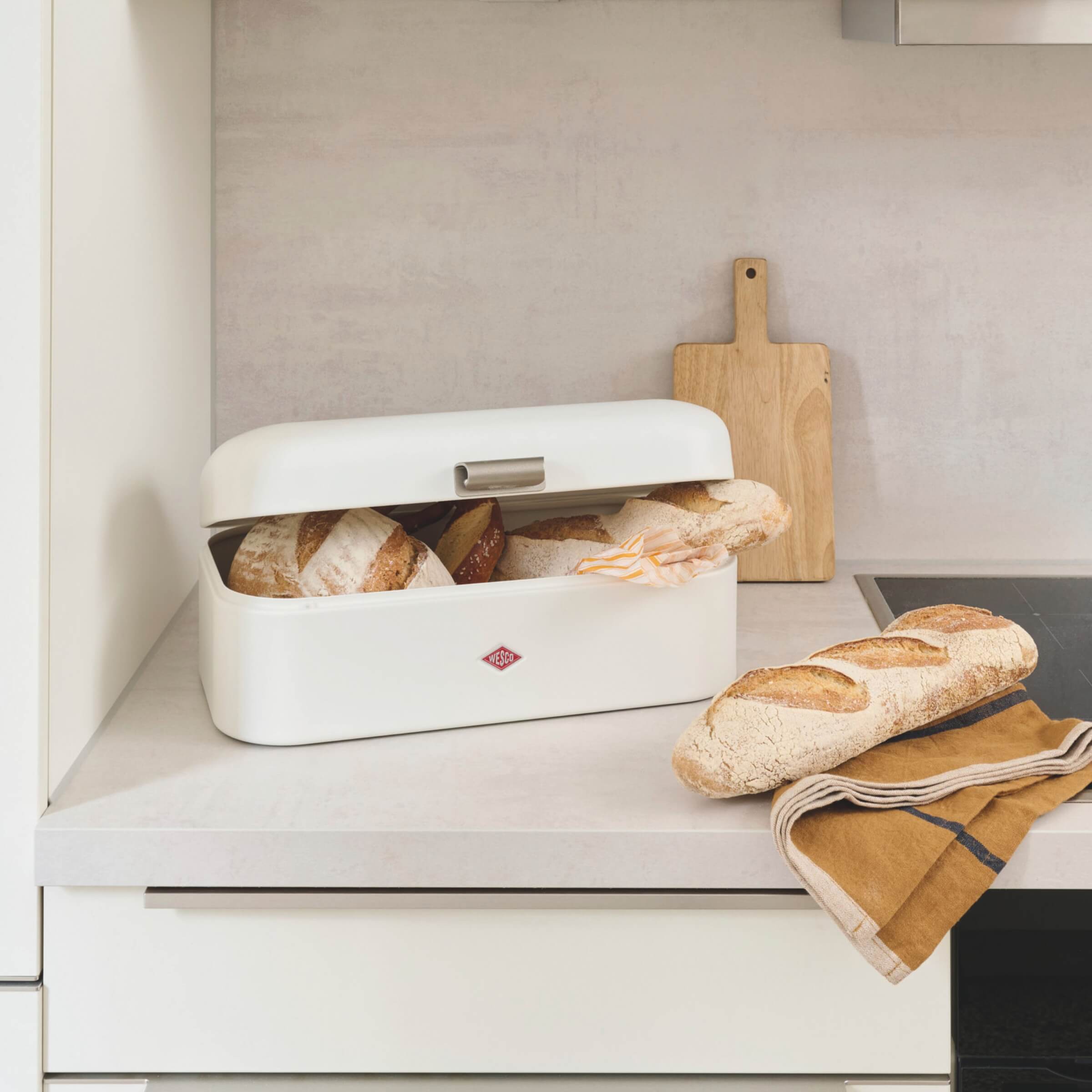 Wesco Grandy Bread bin on a kitchen worktop filled with fresh bread