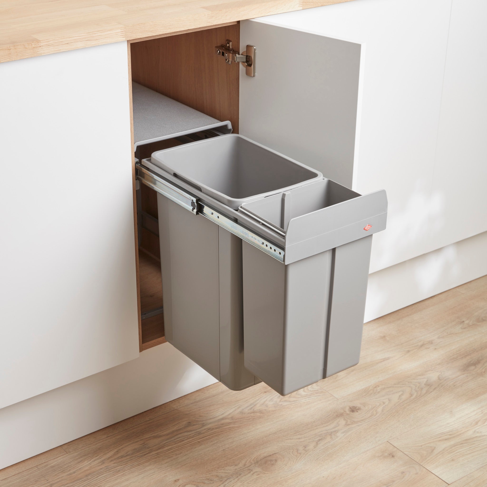 A wesco big bio double 36L recycling bin system pull-out mounted inside a kitchen cabinet, with two bin compartments.