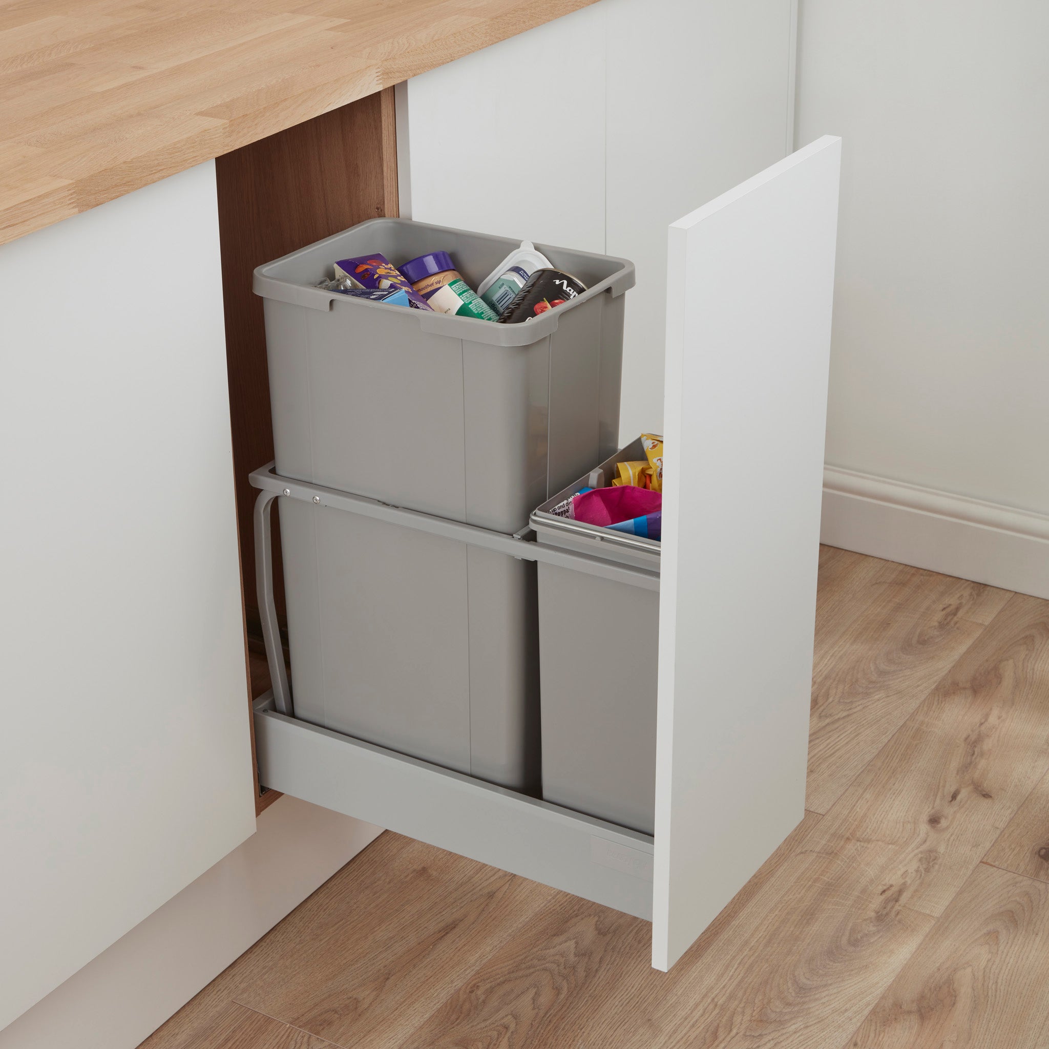 Alu Grey Pullboy AZ bin system with two compartments, installed under a kitchen sink with a pull-out door.