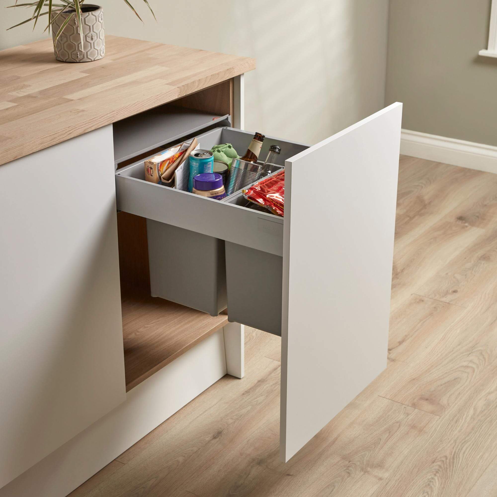 Wesco Pullboy 450mm pull-out waste bin system with 2 compartments filled with recycling rubbish