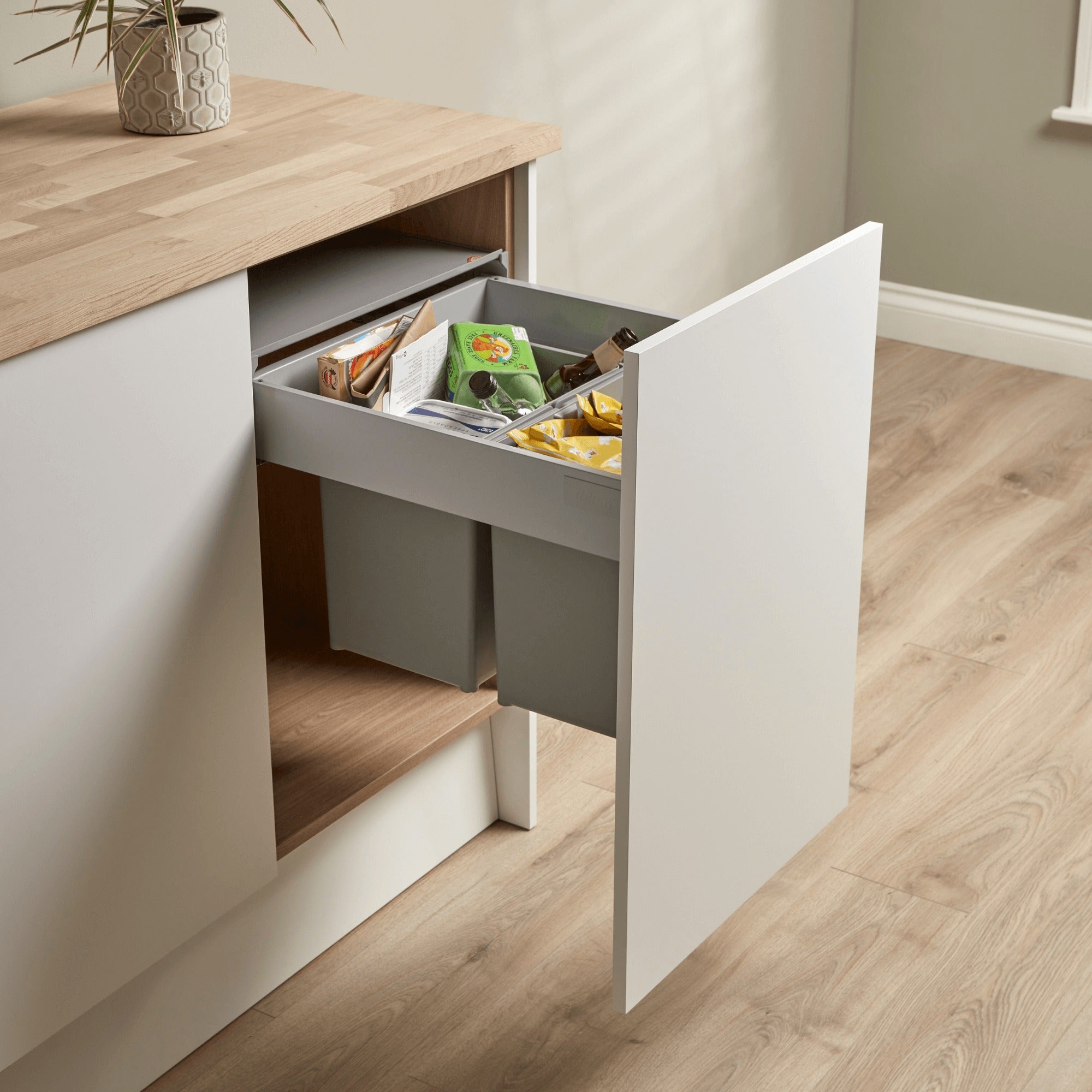 Wesco Pullboy Z Easy 500mm wide 2 compartment integrated pull-out waste bin system filled with recycling rubbish.