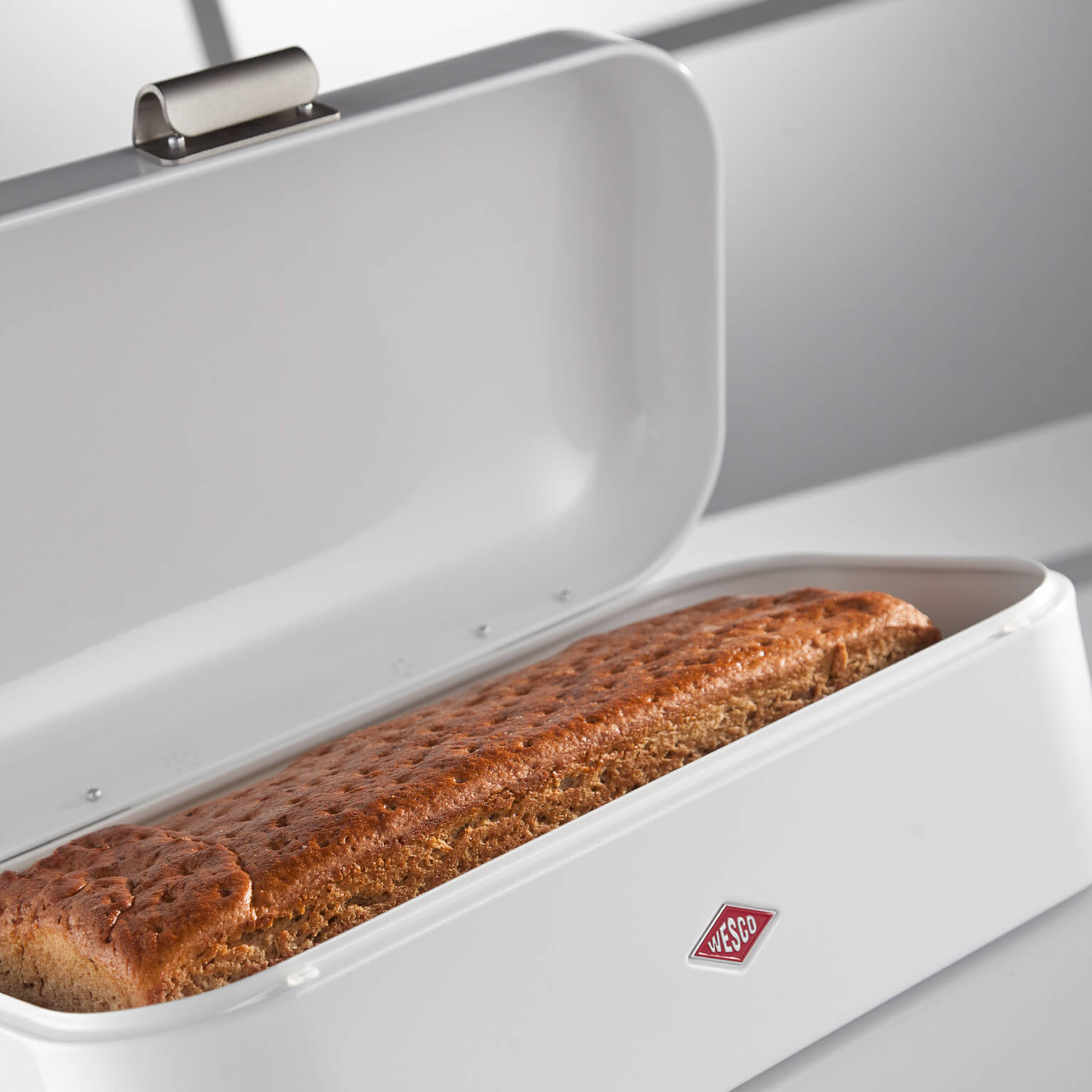 Wesco Grandy bread bin in White when it is open with a loaf of bread inside